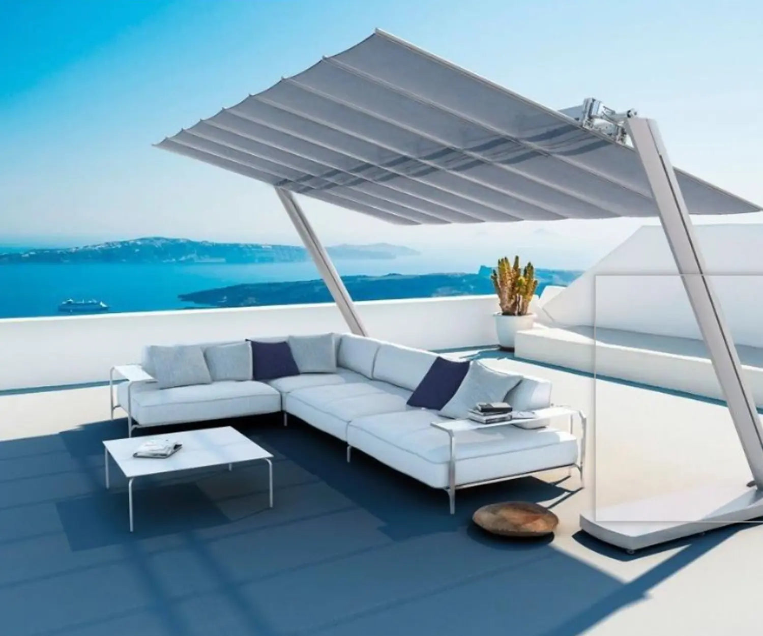 FIM Flexy Modern outdoor furniture set with a retractable canopy on a rooftop with ocean view.